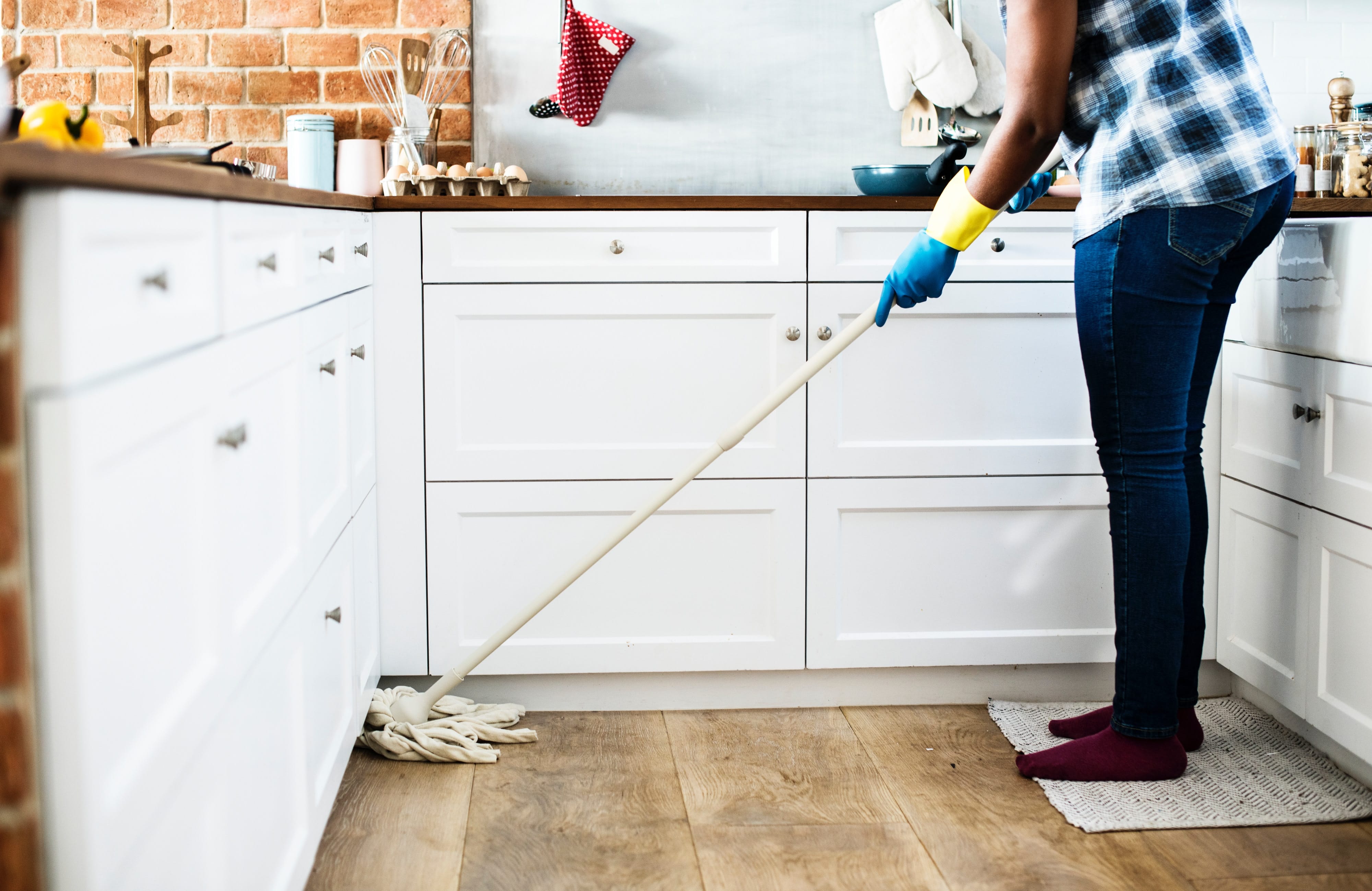 A person mopping a kitchen floor